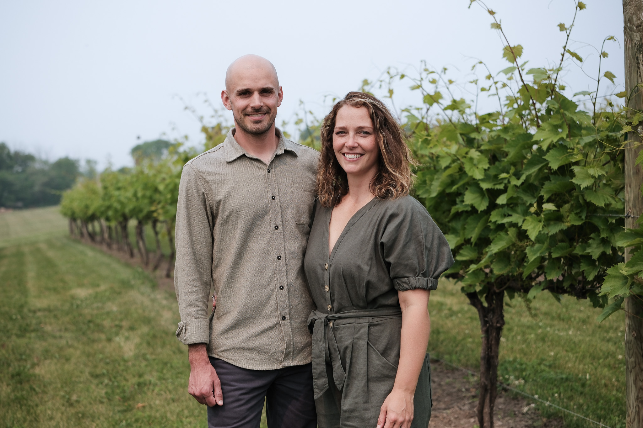 Owners of Carlos Creek in Alexandria, MN stand in the Minnesota vineyard.