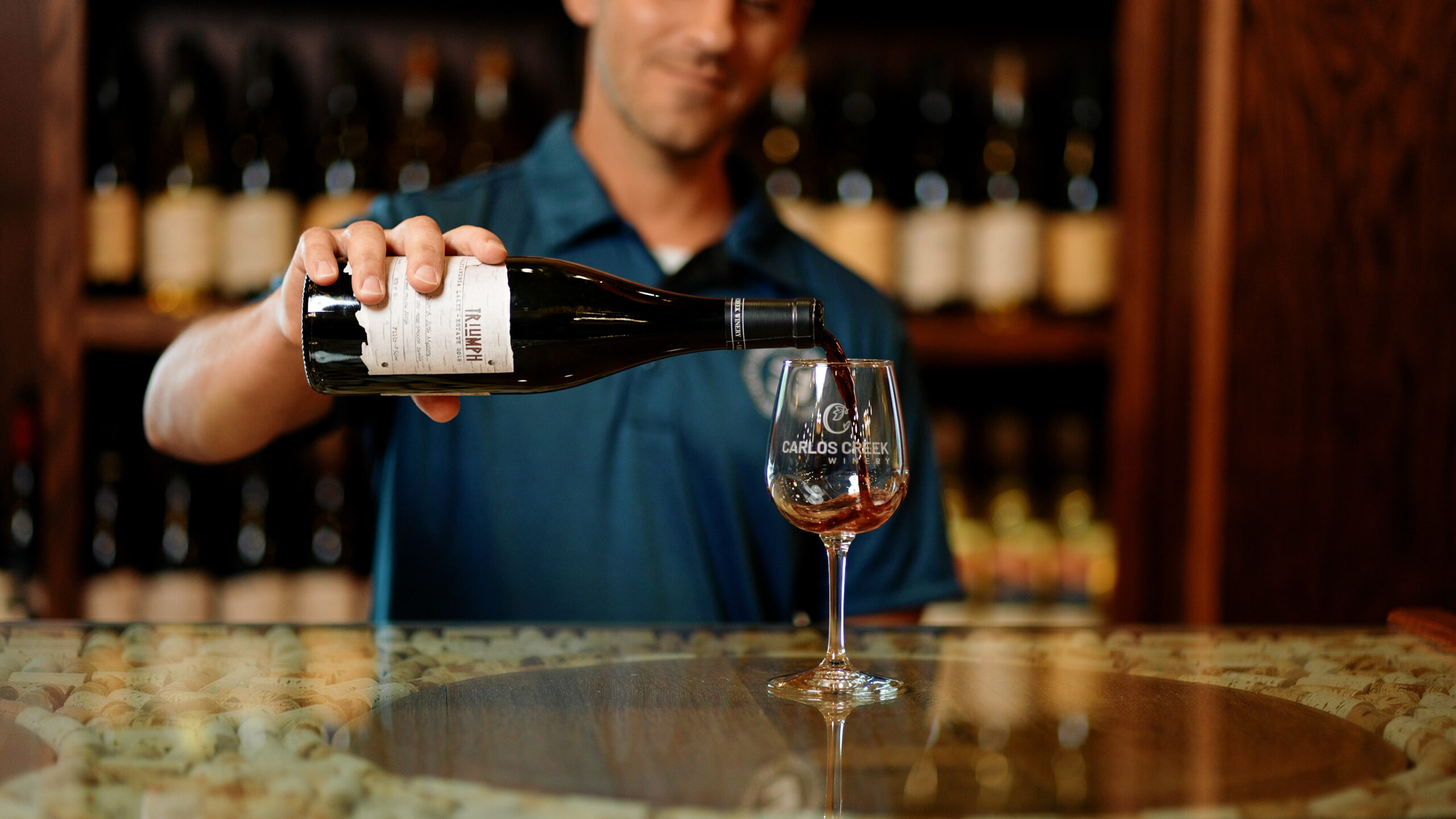 Staff pouring wine at Carlos Creek Winery's tasting room in Alexandria, MN.