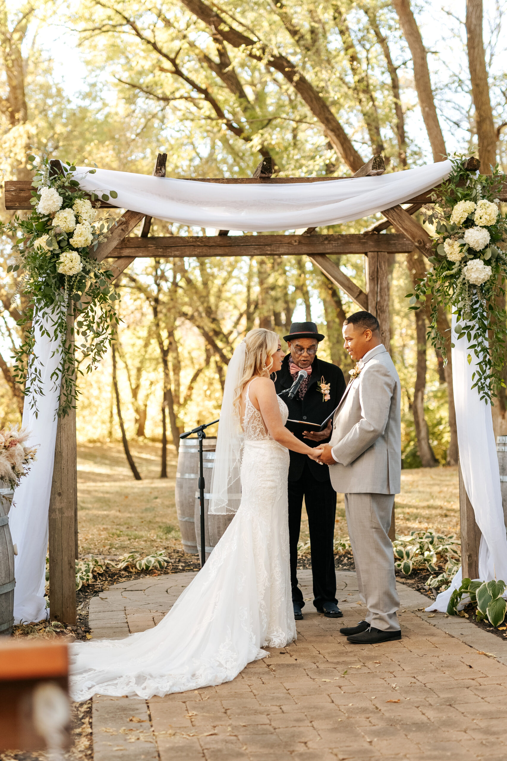 couple standing under the ceremony arbor