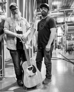 band poses with guitar